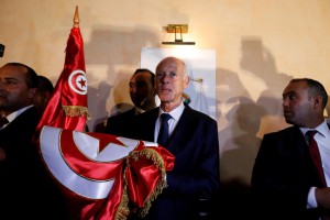 Tunisian presidential candidate Kais Saied reacts after exit poll results were announced in a second round runoff of the presidential election in Tunis